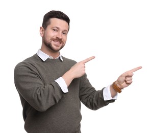 Portrait of handsome bearded businessman pointing at something on white background