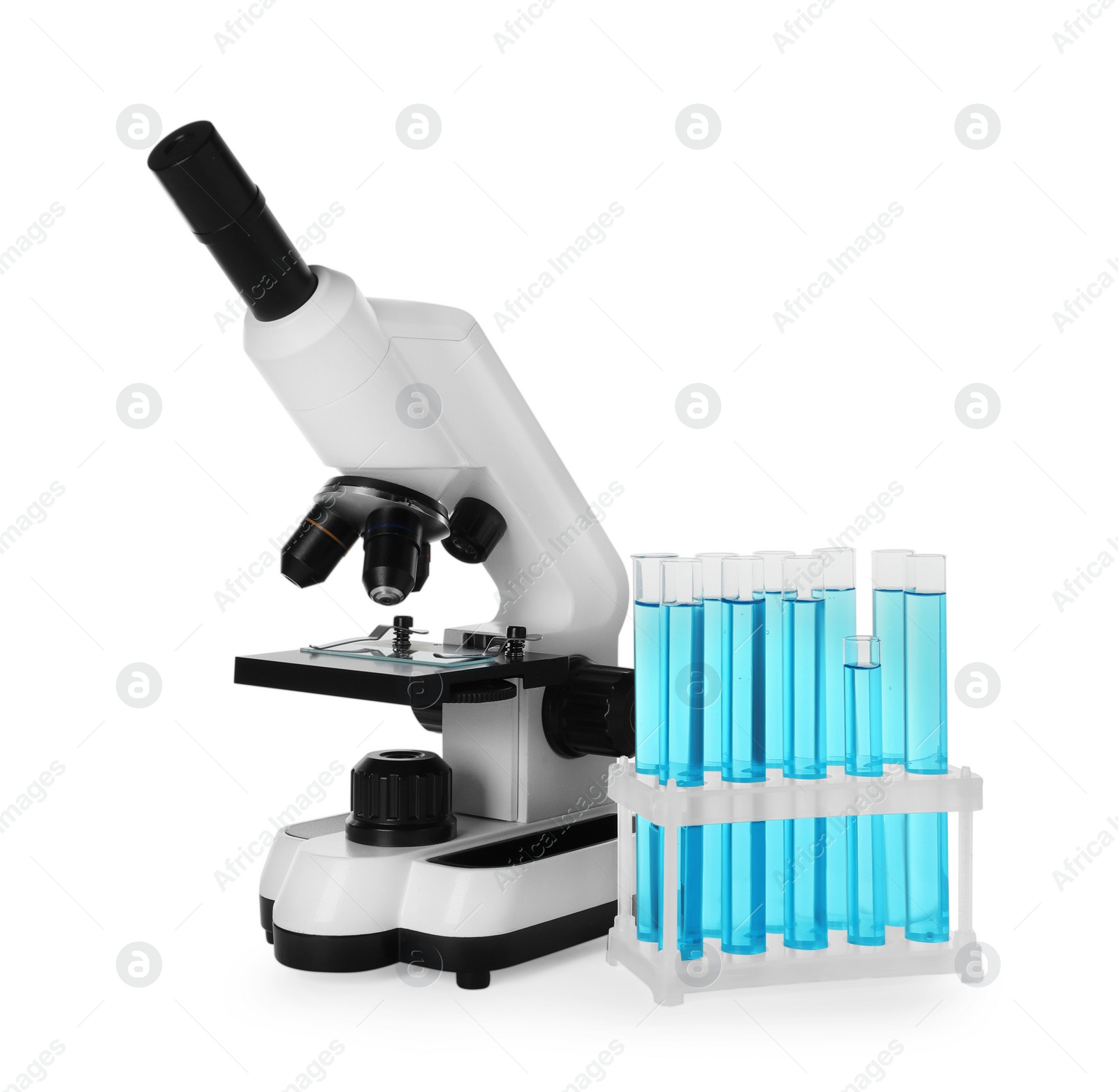 Photo of Test tubes with light blue liquid and microscope isolated on white