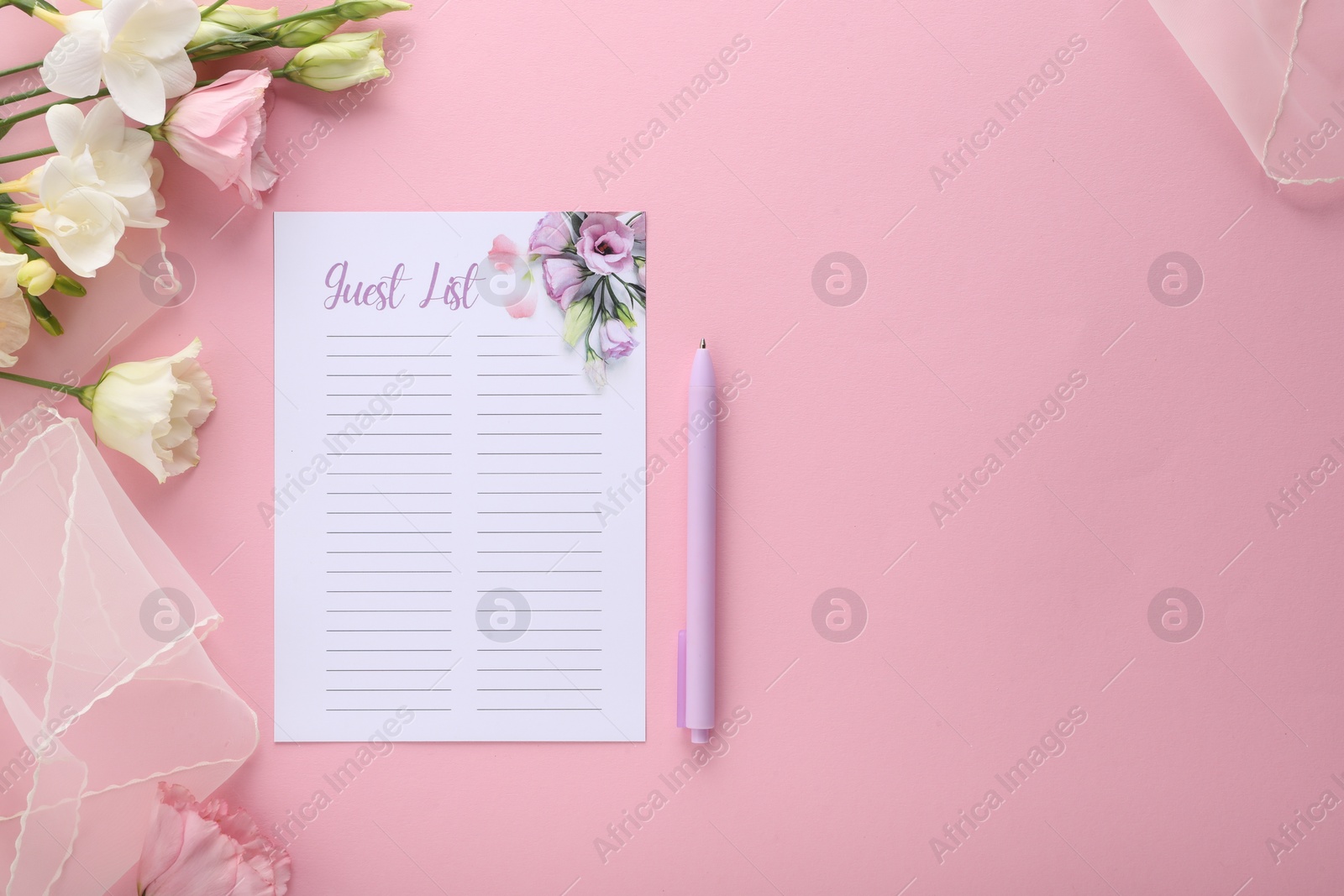 Photo of Guest list, pen, tulle fabric and beautiful flowers on pink background, flat lay. Space for text