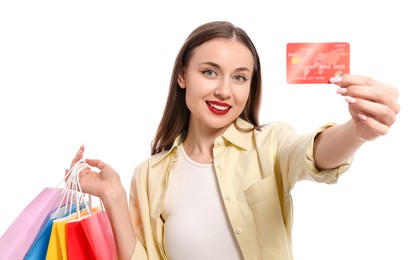 Photo of Stylish young woman with shopping bags and credit card white background