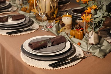 Beautiful autumn place setting and decor for festive dinner on table