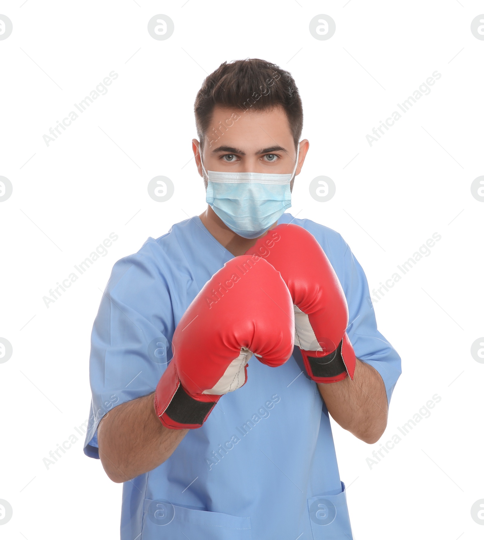 Photo of Doctor with protective mask and boxing gloves on white background. Strong immunity concept