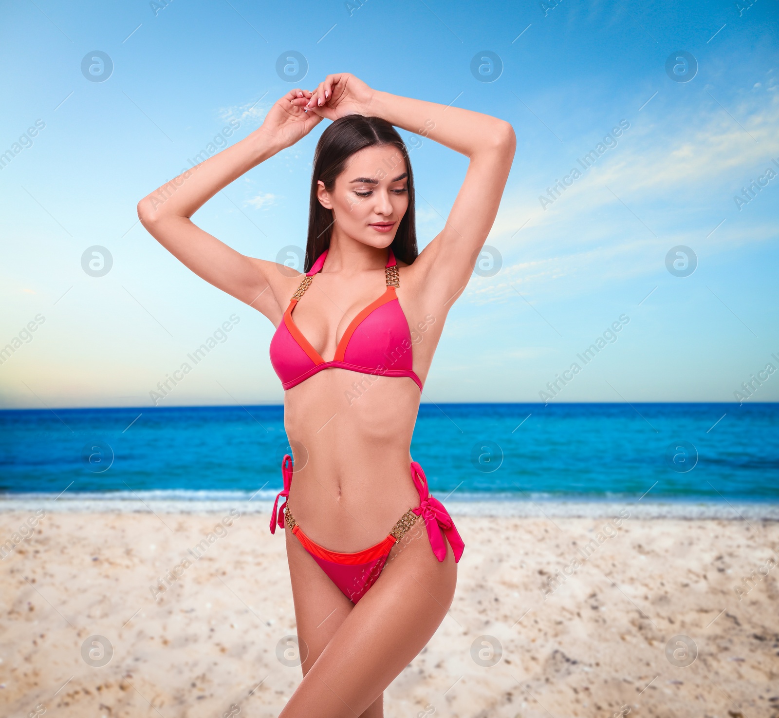 Image of Beautiful woman in stylish pink bikini on sandy beach near sea