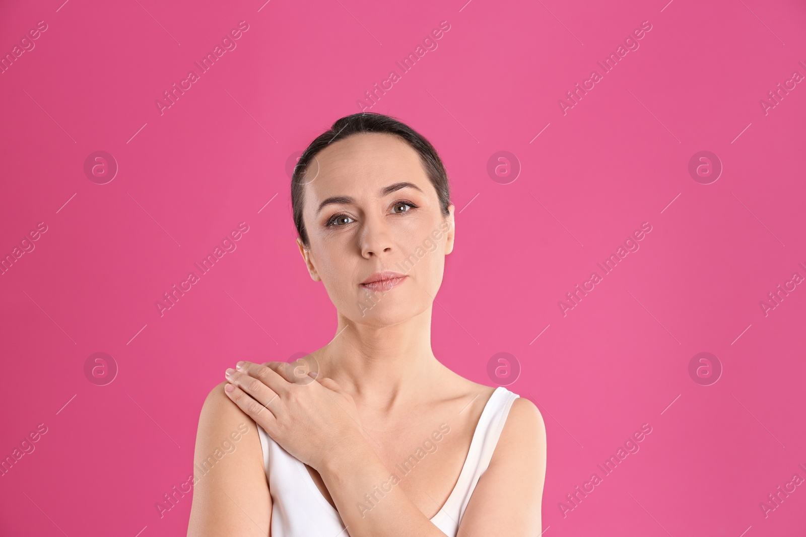 Photo of Portrait of beautiful mature woman on pink background