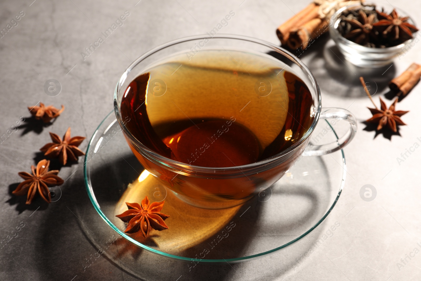 Photo of Aromatic tea with anise stars on light grey table