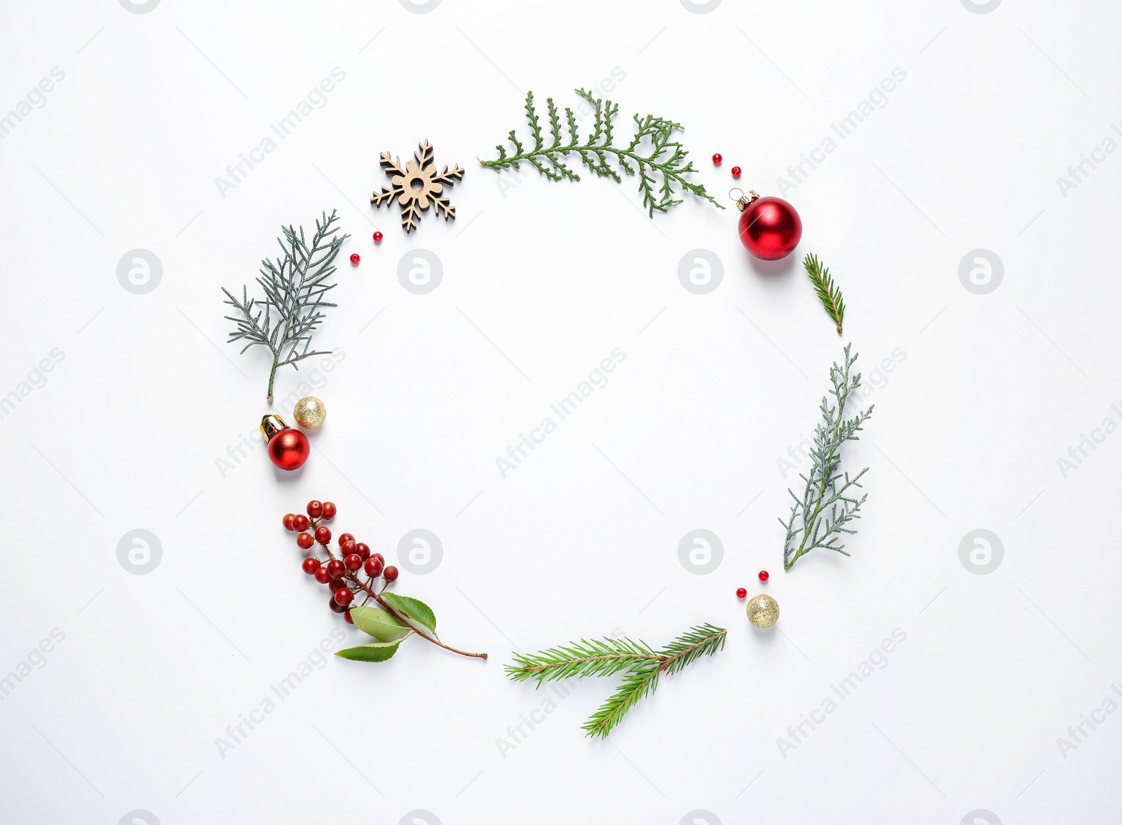 Photo of Flat lay composition with Christmas tree branches and festive decor on white background. Space for text