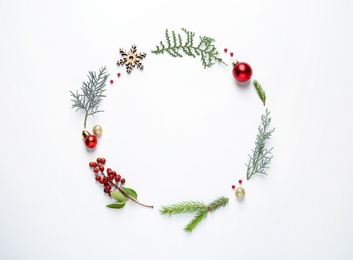 Photo of Flat lay composition with Christmas tree branches and festive decor on white background. Space for text