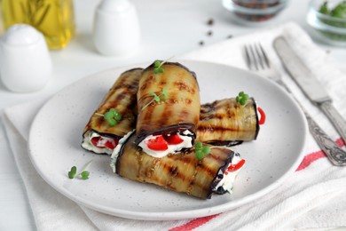 Photo of Delicious baked eggplant rolls served on white table
