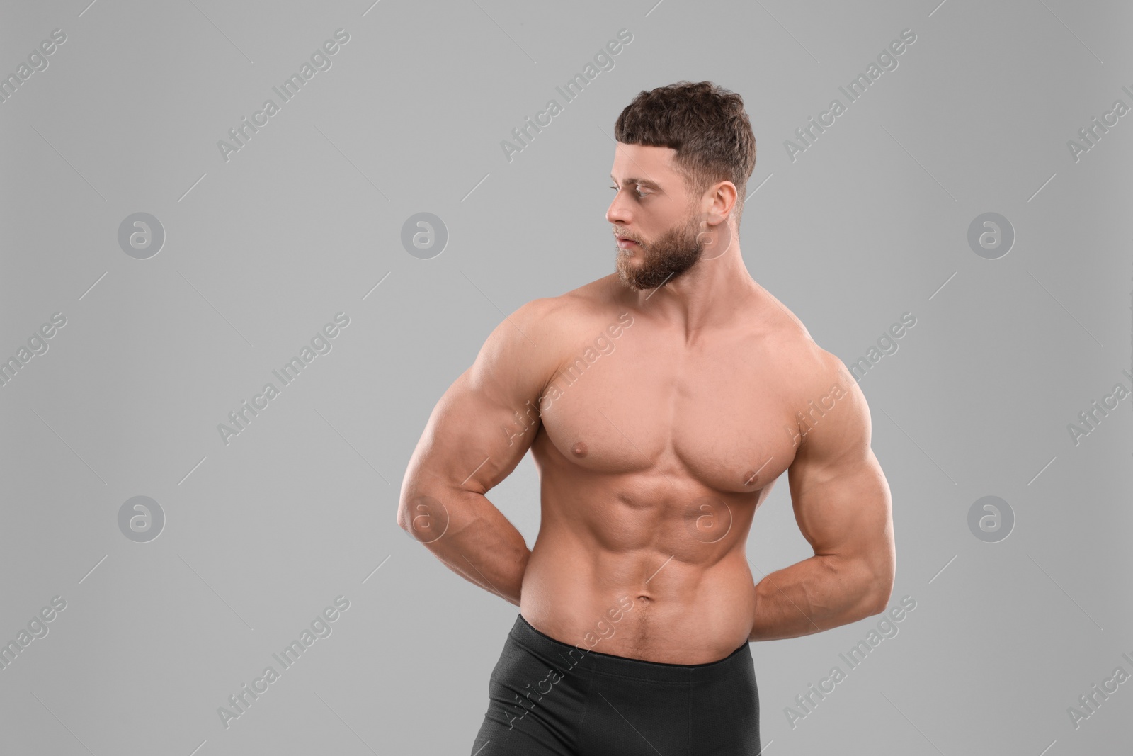 Photo of Handsome muscular man on light grey background, space for text. Sexy body