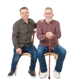 Photo of Happy senior men sitting on chairs against white background