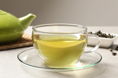 Glass cup of Tie Guan Yin oolong tea on table