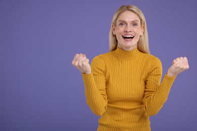 Photo of Portrait of happy surprised woman on violet background, space for text