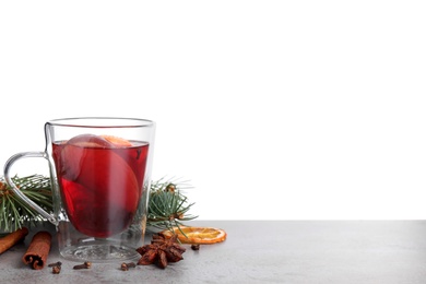 Photo of Tasty aromatic mulled wine on table against white background