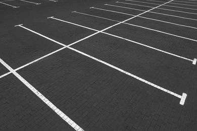 Photo of Empty car parking lots with white marking lines outdoors