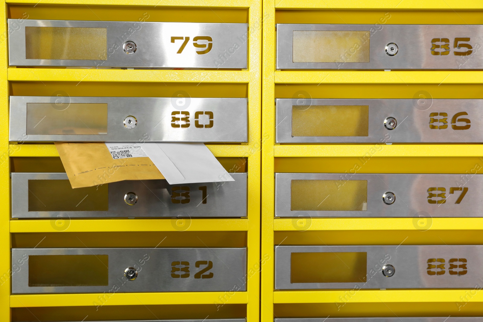 Photo of Metal mailboxes with keyholes, numbers and correspondence in post office