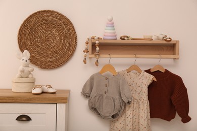 Nursery interior with stylish furniture, clothes and accessories
