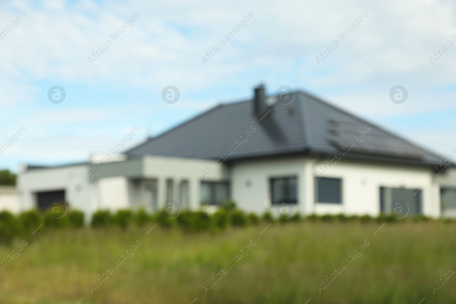 Photo of Blurred view of beautiful house under blue sky