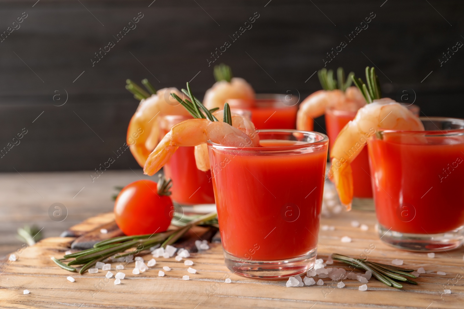 Photo of Delicious shrimp cocktail shots on wooden table