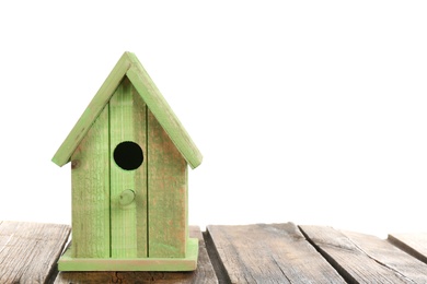 Beautiful green bird house on wooden table against white background, space for text