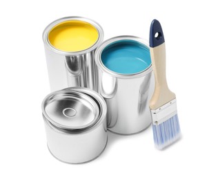 Cans of yellow and blue paints with brush on white background