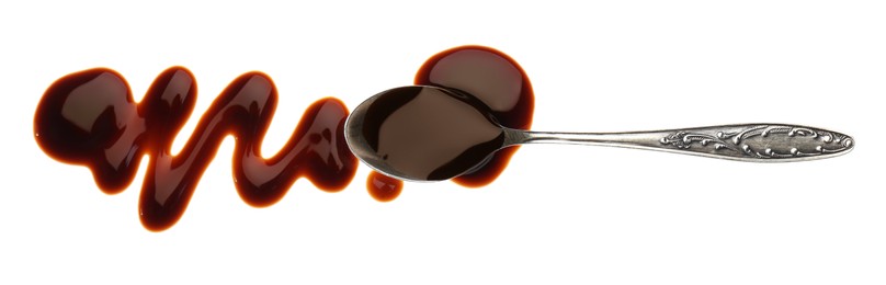 Photo of Smear of soy sauce and spoon on white background, top view
