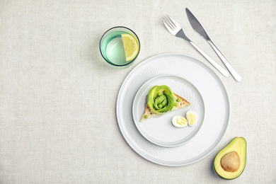 Photo of Tasty breakfast with crisp avocado  toast on table, top view