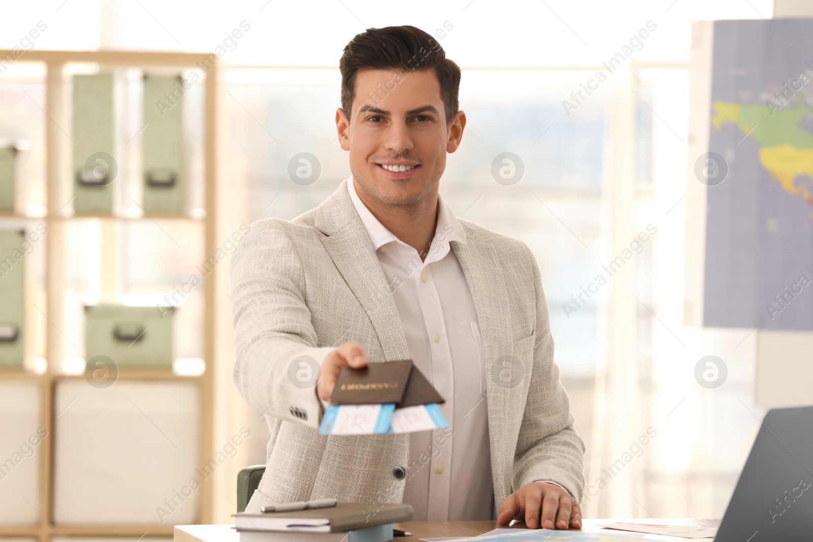 Photo of Travel agent with tickets and passports in office