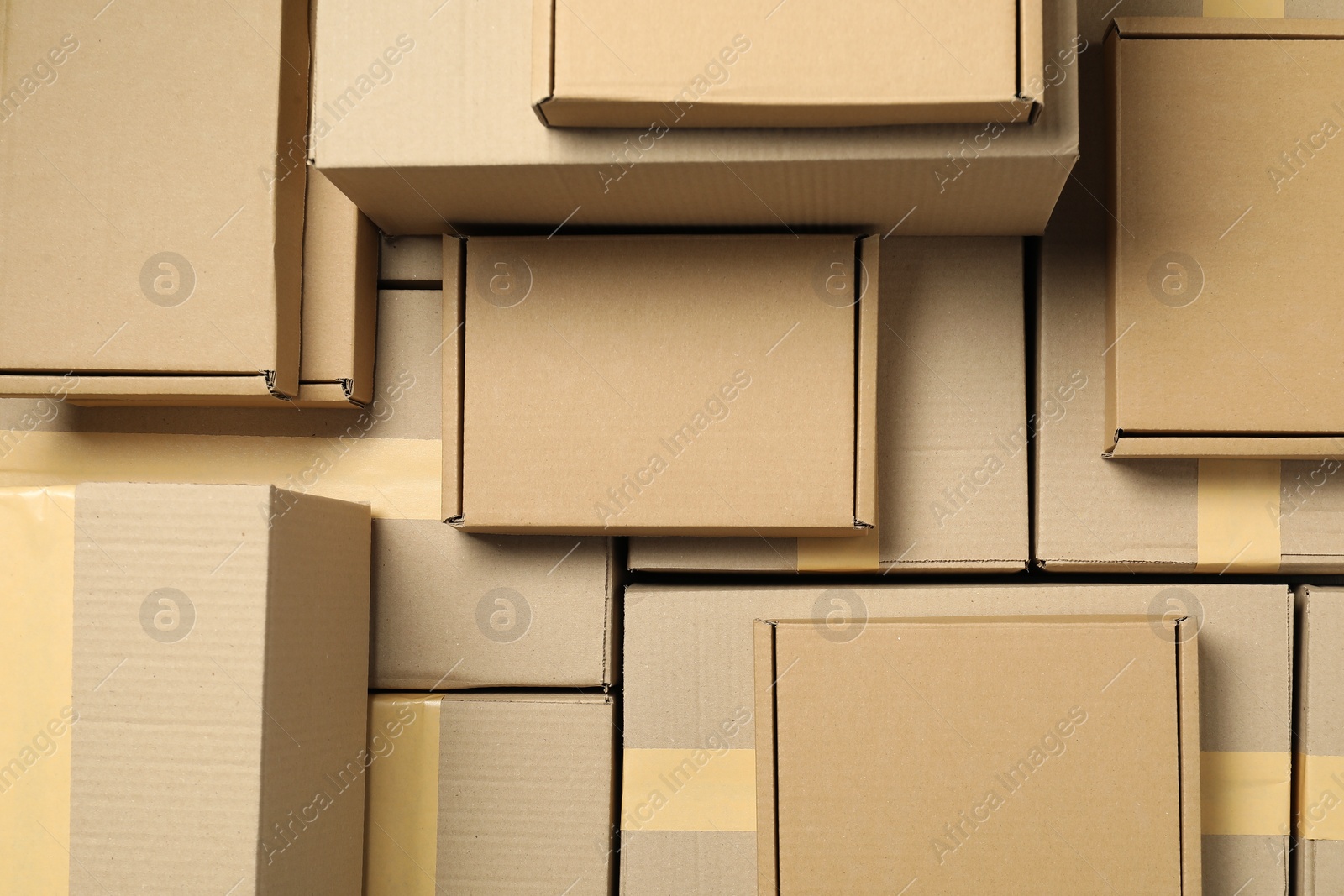 Photo of Many cardboard boxes as background, top view. Packaging goods