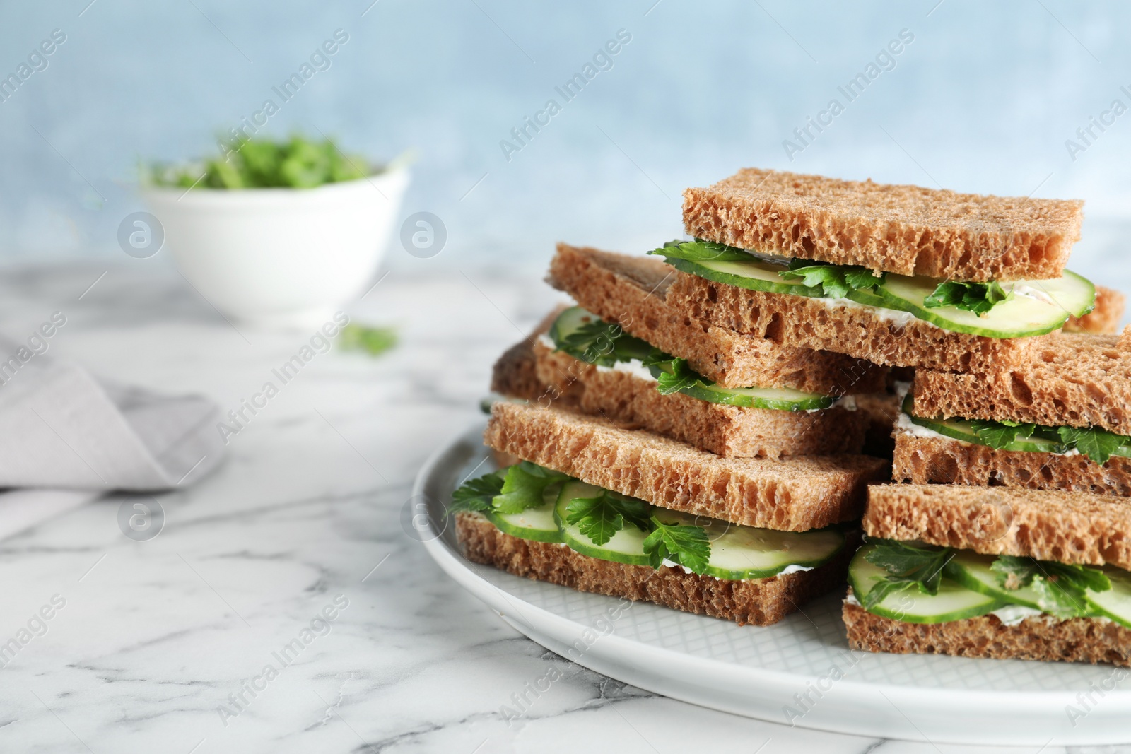 Photo of Plate with traditional English cucumber sandwiches on table. Space for text