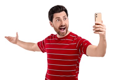 Photo of Emotional man taking selfie with smartphone on white background