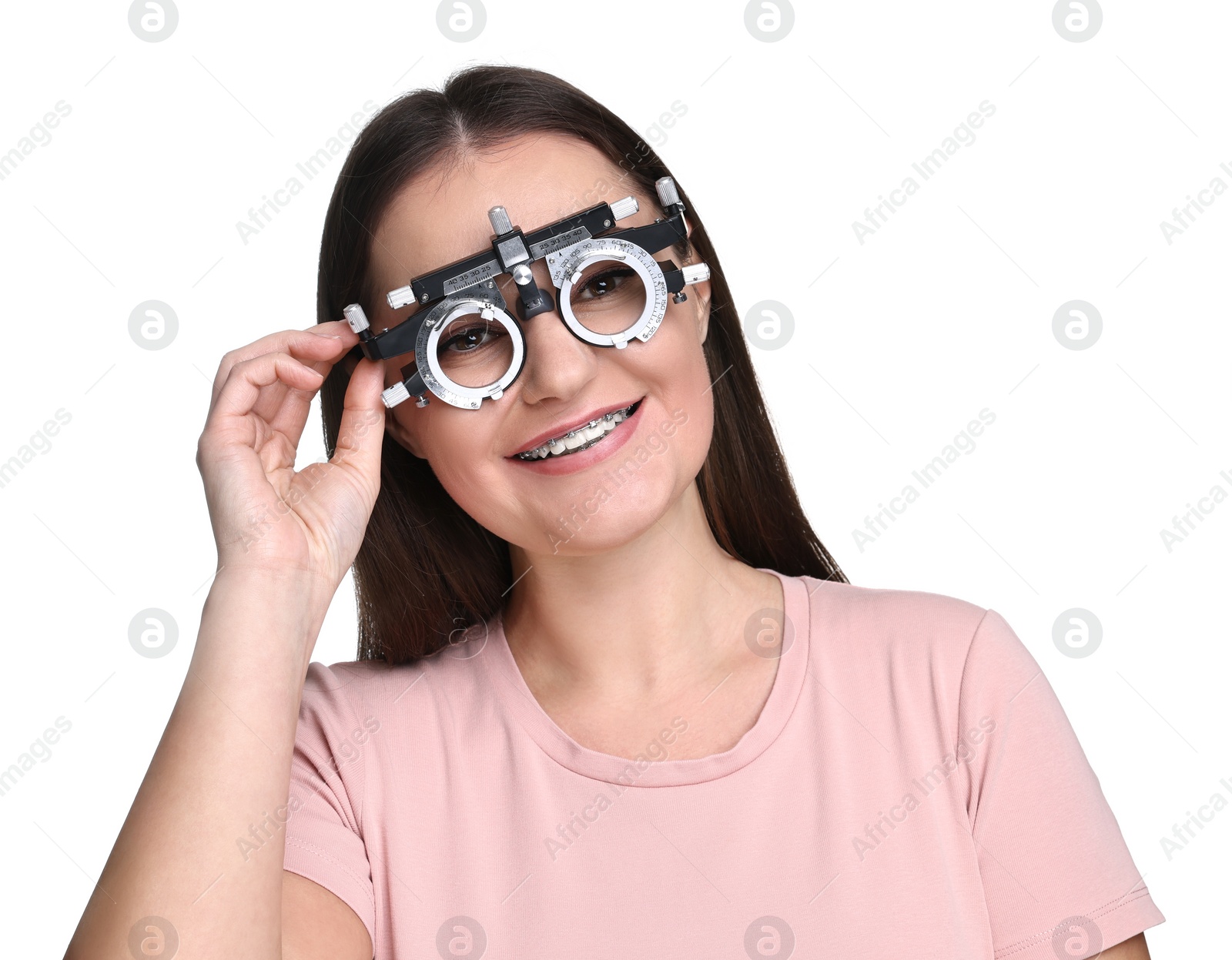 Photo of Vision testing. Young woman with trial frame on white background