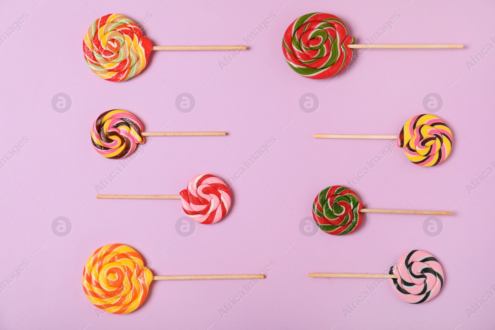 Photo of Flat lay composition with different candies on color background