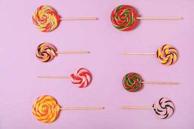 Photo of Flat lay composition with different candies on color background