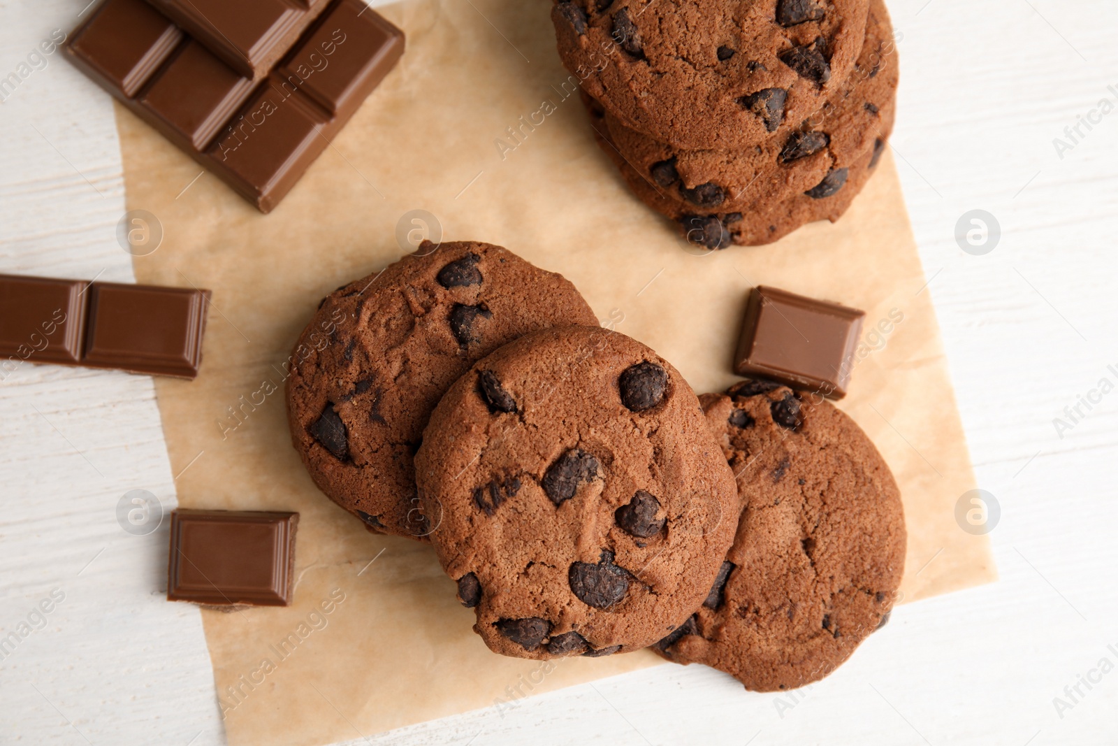 Photo of Tasty chocolate chip cookies on light background, top view