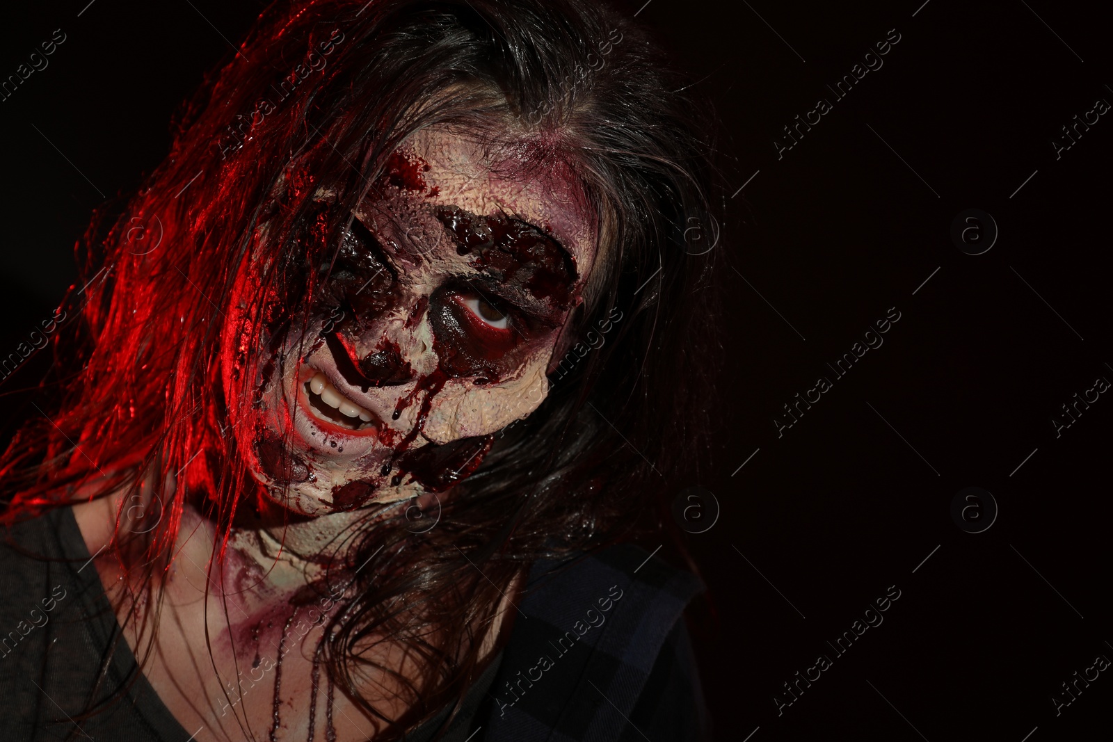 Photo of Scary zombie on dark background, space for text. Halloween monster