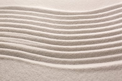 White sand with pattern as background, closeup. Concept of zen and harmony