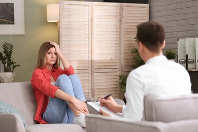 Photo of Male psychologist with client in office