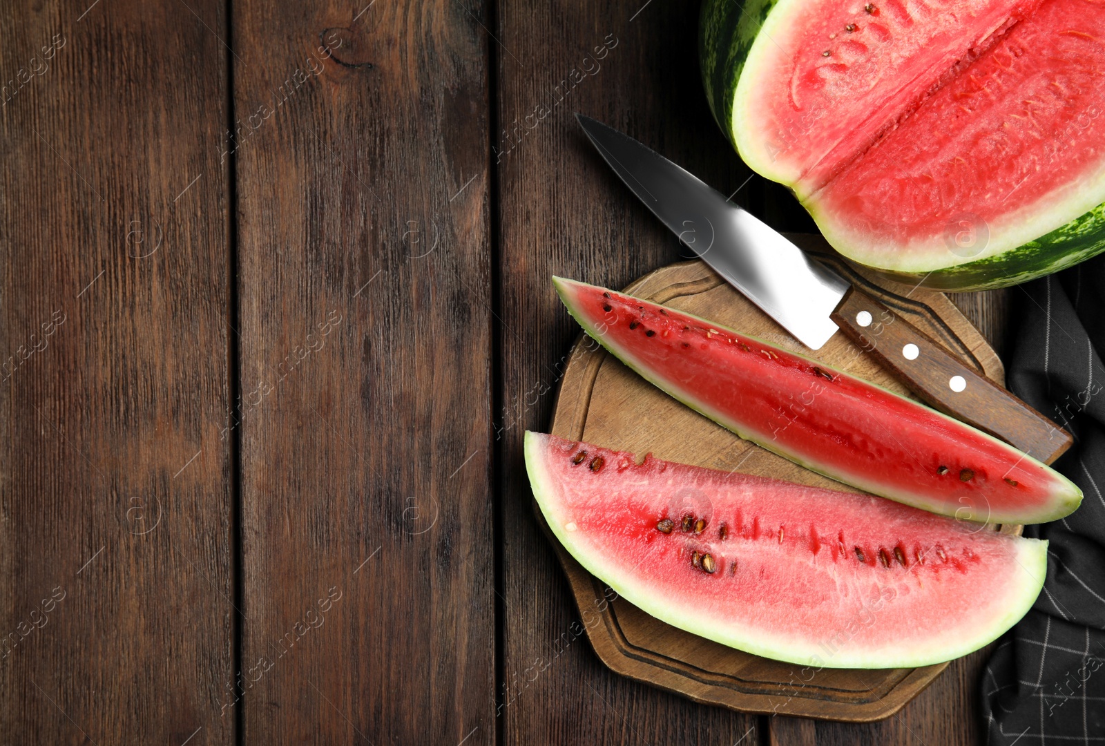 Photo of Yummy watermelon on wooden table, flat lay. Space for text