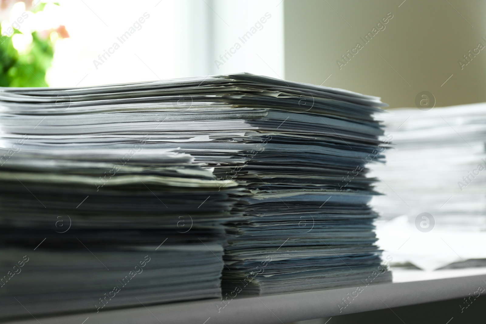 Photo of Stacks of documents on desk in office