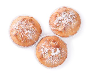 Photo of Tasty muffins powdered with sugar on white background, top view