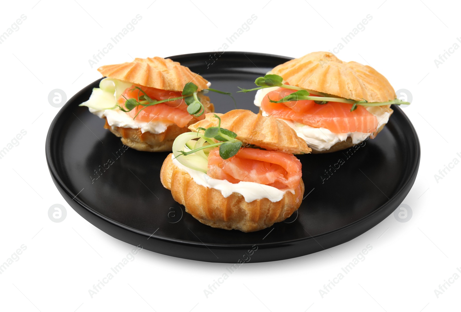 Photo of Delicious profiteroles with cream cheese and salmon isolated on white