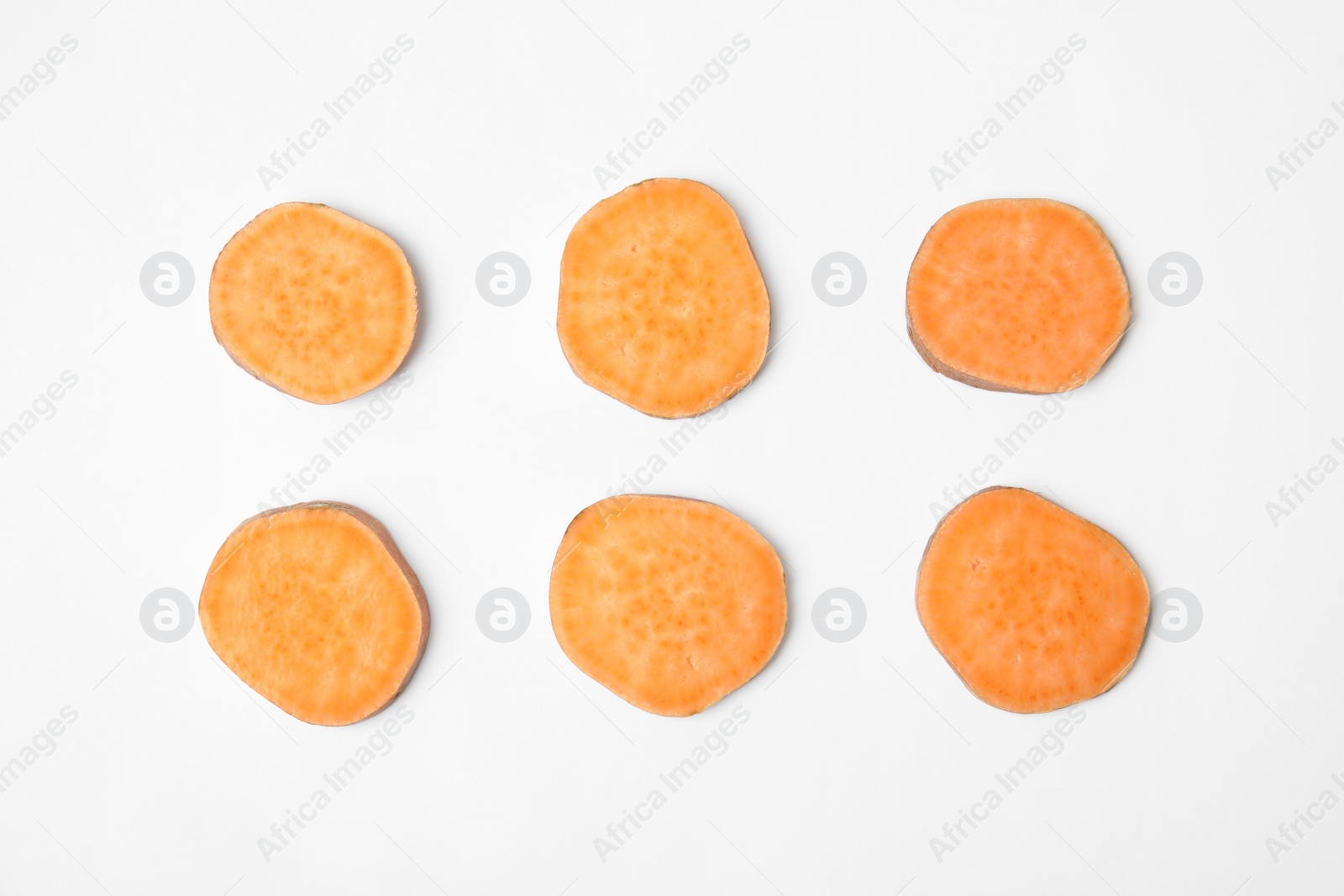 Photo of Composition with slices of sweet potato on white background, top view