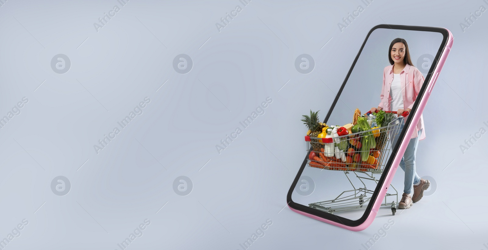 Image of Online purchases. Woman with shopping cart full of different products walking through smartphone on grey background. Banner design with space for text