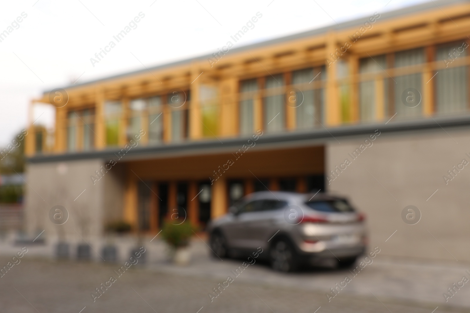 Photo of Car near big house outdoors, blurred view. Real estate for rent