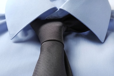 Photo of Color male necktie on blue shirt, closeup