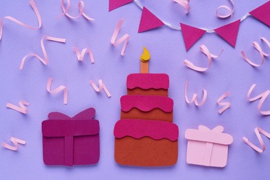 Photo of Birthday party. Paper cake and gift boxes on lilac background, flat lay