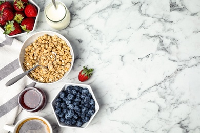 Photo of Tasty breakfast served on white marble table, flat lay. Space for text