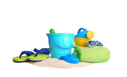 Photo of Set of plastic beach toys, accessories and pile of sand on white background