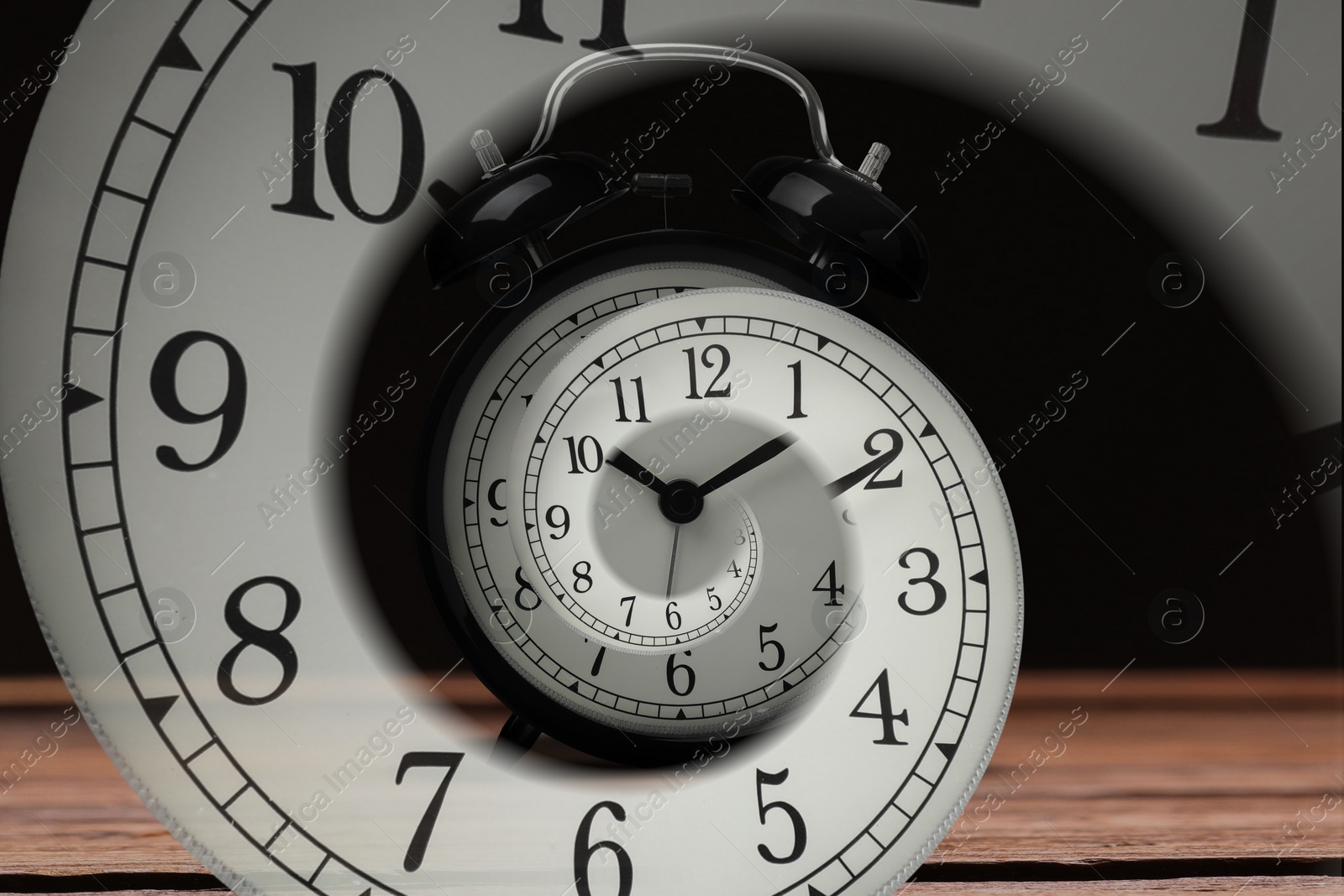 Image of Infinity and other time related concepts. Alarm clock face twisted in spiral, fractal pattern