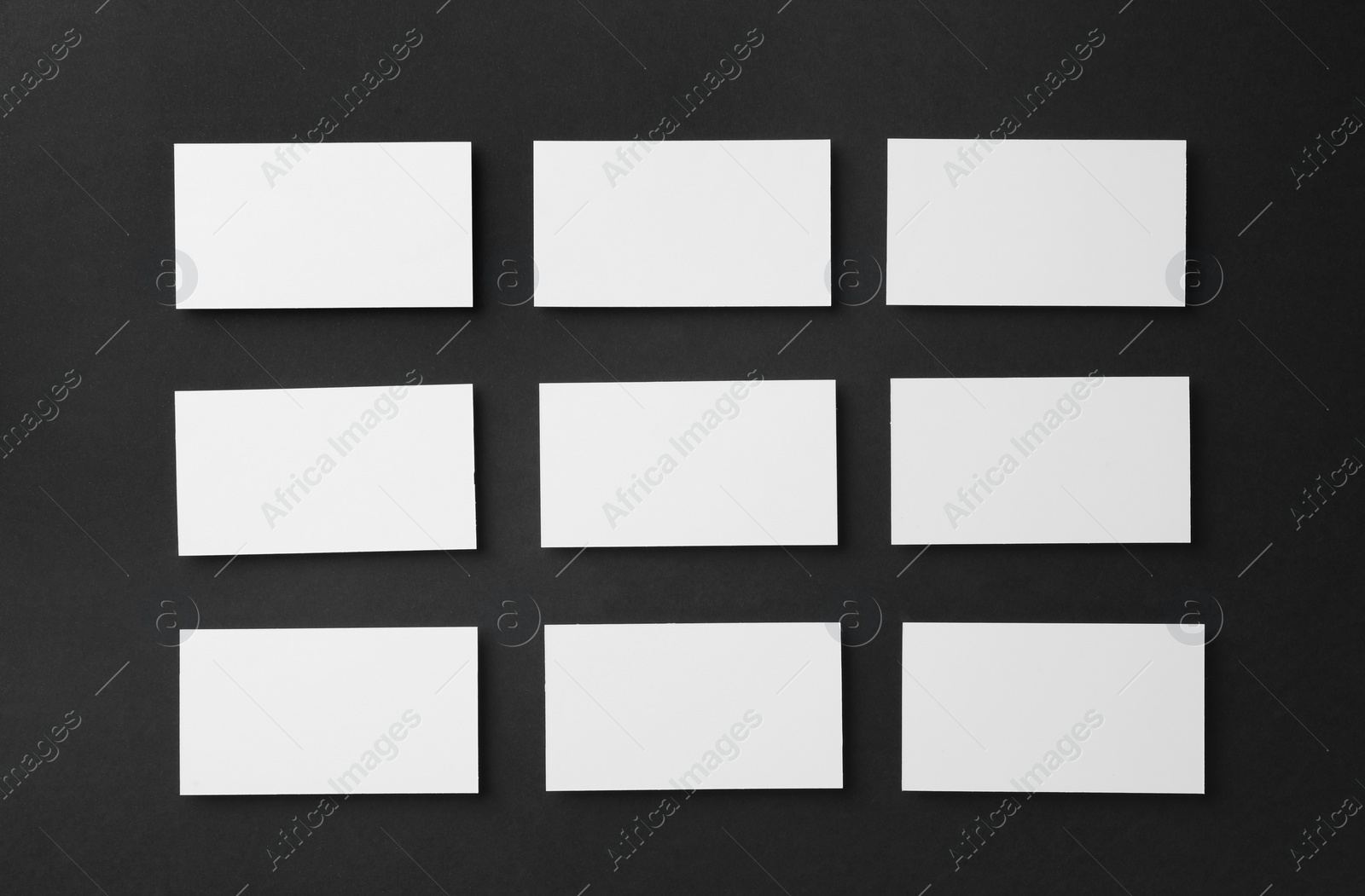 Photo of Blank business cards on black background, flat lay. Mockup for design